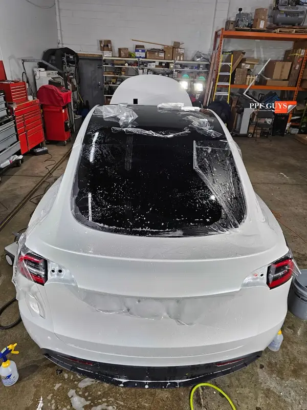 White Tesla Model Y Performance, Stealth, emblems. Photo 22 of 60.