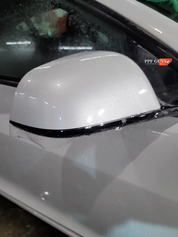 White Tesla Model 3, Front end, partial A-pillars, tinted headlights and fogs. Photo 14 of 18.