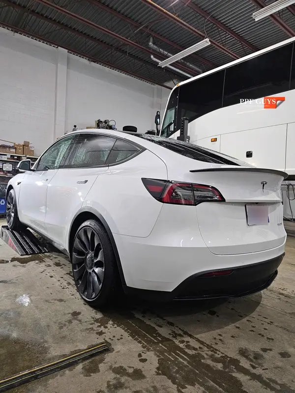 White Tesla Model Y Performance, Stealth, emblems. Photo 57 of 60.