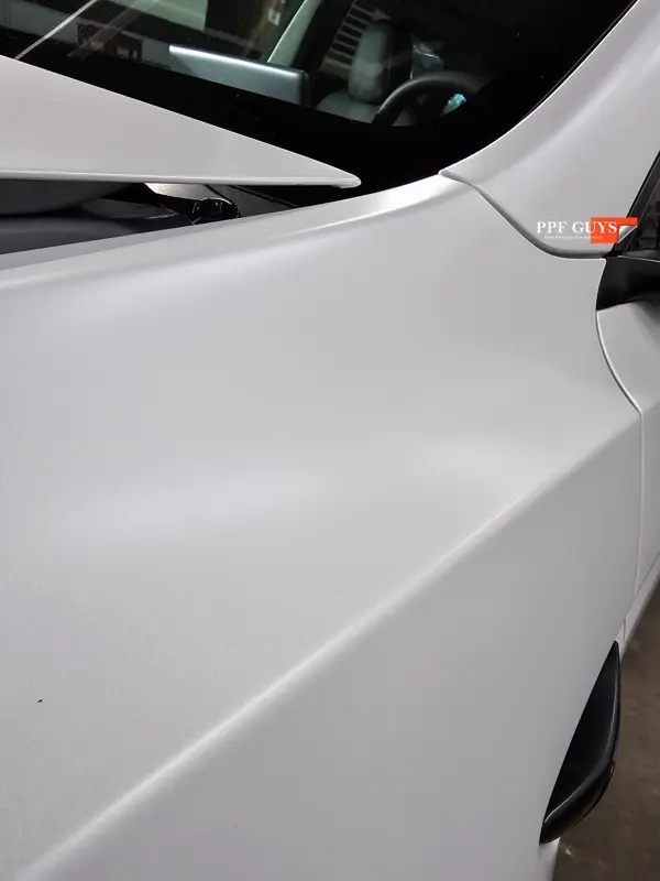 White Tesla Model Y Performance, Stealth, emblems. Photo 39 of 60.