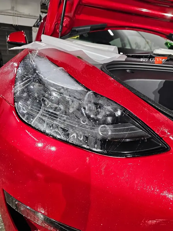 Red Tesla Model 3, Front end, partial A-pillars and rockers. Photo 13 of 30.