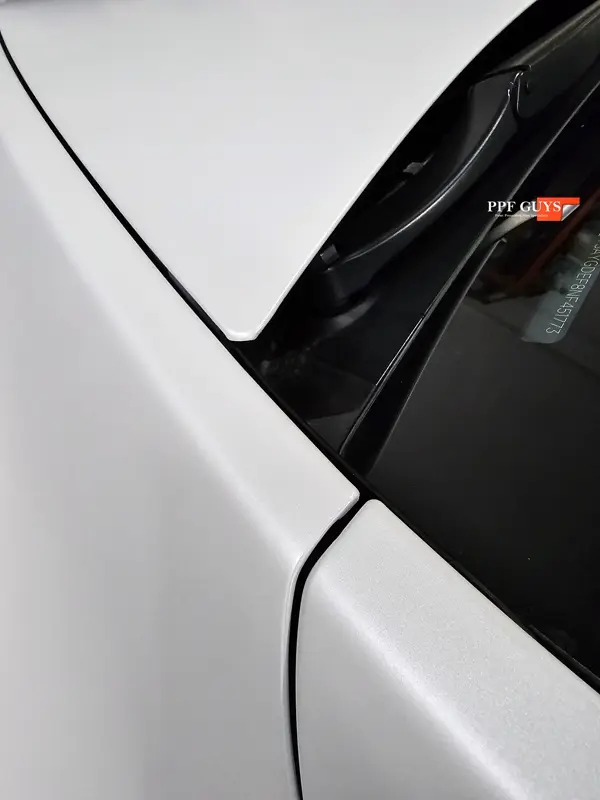 White Tesla Model Y Performance, Stealth, emblems. Photo 34 of 60.