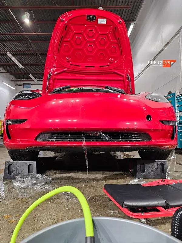 Red Tesla Model 3, Front end, partial A-pillars and rockers. Photo 10 of 30.