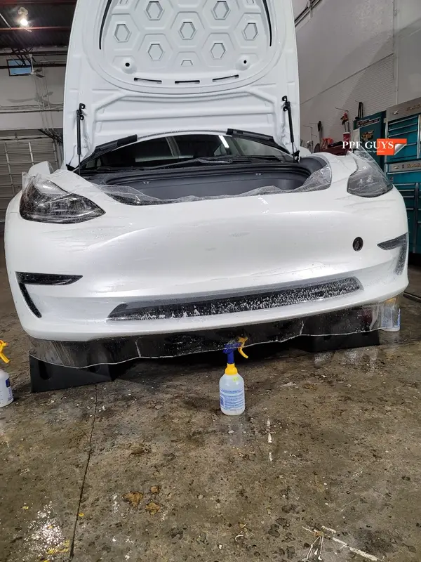 White Tesla Model 3, Front end, partial A-pillars, tinted headlights and fogs