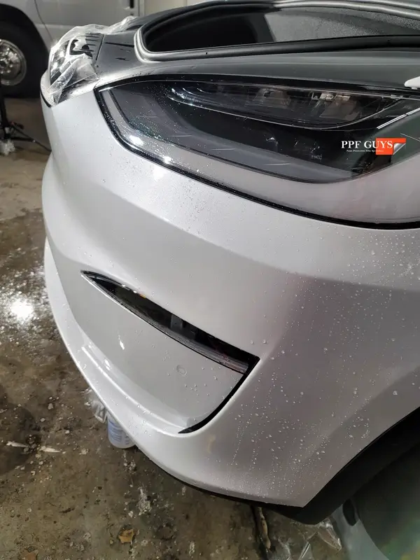 White Tesla Model X, Front end, rear bumper. Photo 15 of 15.
