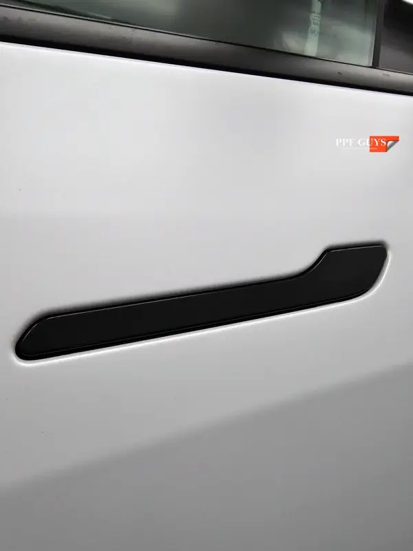 White Tesla Model Y Performance, Stealth, emblems. Photo 28 of 60.
