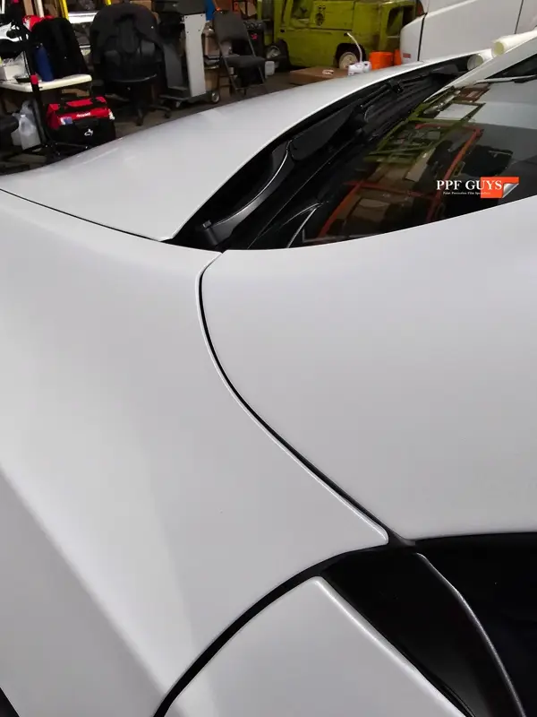 White Tesla Model Y Performance, Stealth, emblems. Photo 32 of 60.