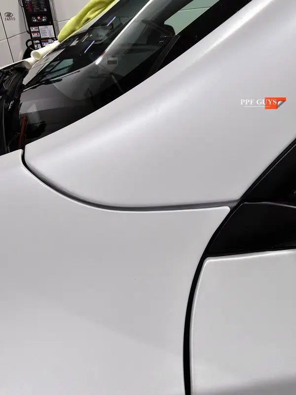 White Tesla Model Y Performance, Stealth, emblems. Photo 31 of 60.