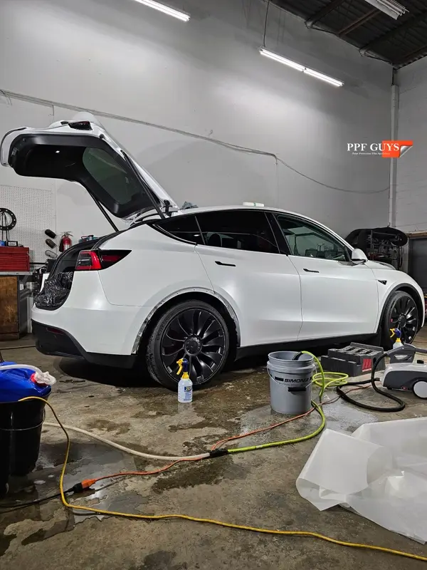 White Tesla Model Y Performance, Stealth, emblems. Photo 41 of 60.