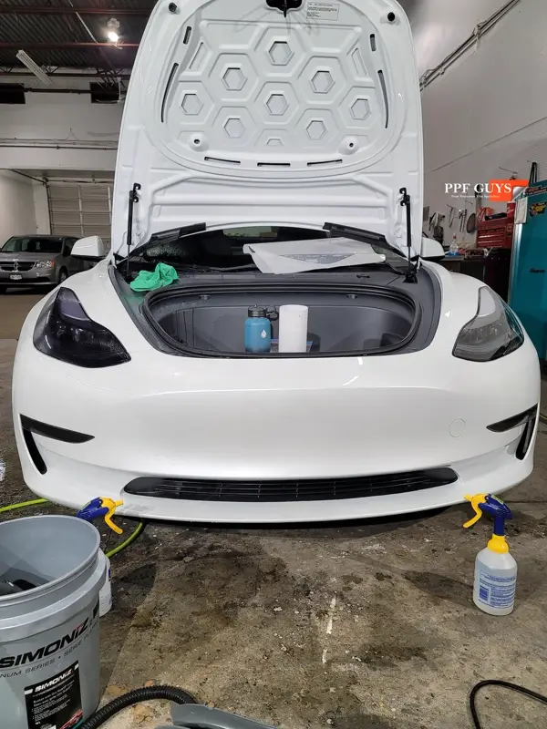 White Tesla Model 3, Front end, partial A-pillars, tinted headlights and fogs. Photo 18 of 18.