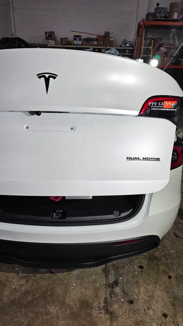 White Tesla Model Y Performance, Stealth, emblems. Photo 54 of 60.