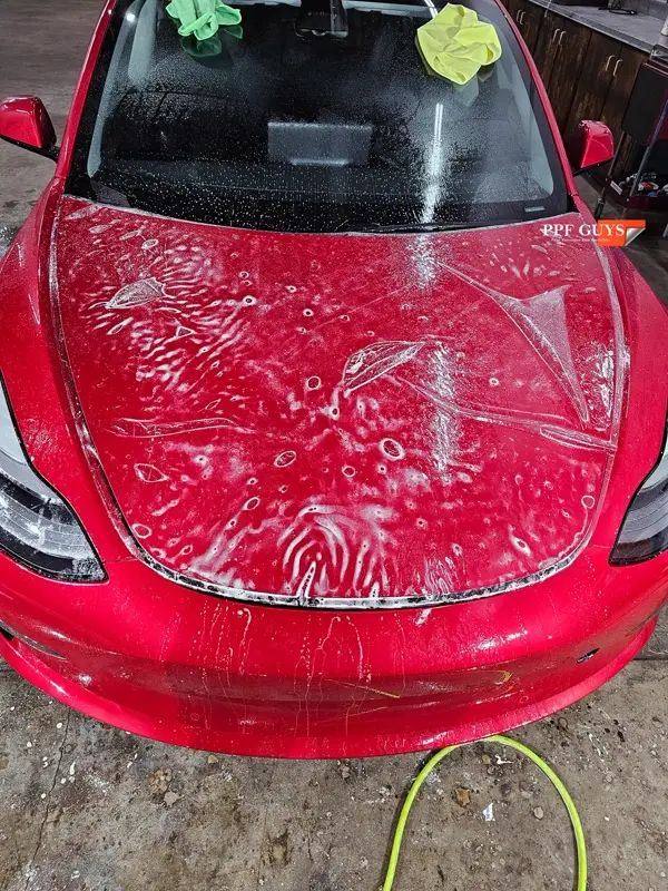 Red Tesla Model 3, Front end, partial A-pillars and rockers. Photo 12 of 30.