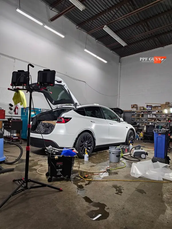 White Tesla Model Y Performance, Stealth, emblems. Photo 40 of 60.