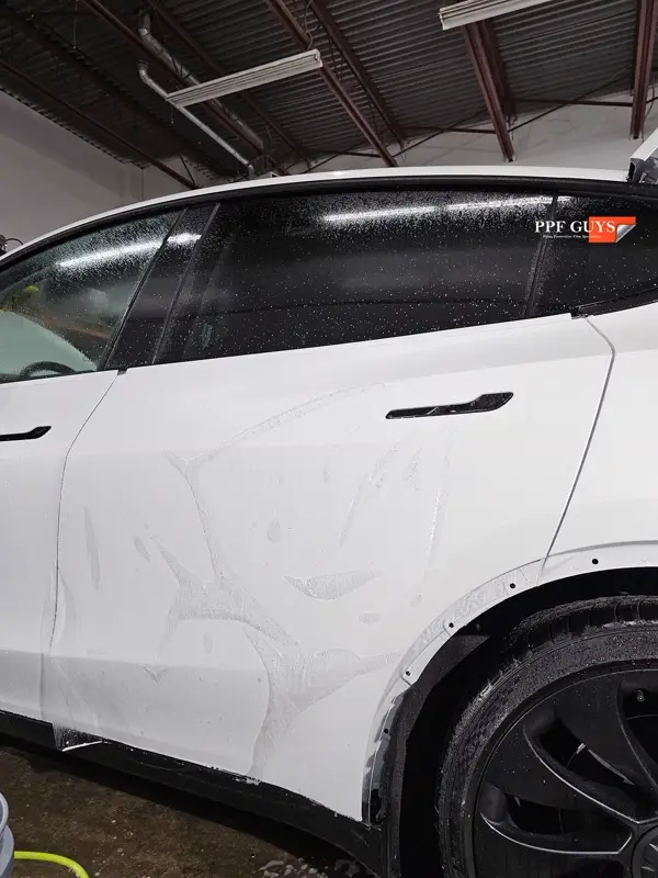 White Tesla Model Y Performance, Stealth, emblems. Photo 11 of 60.