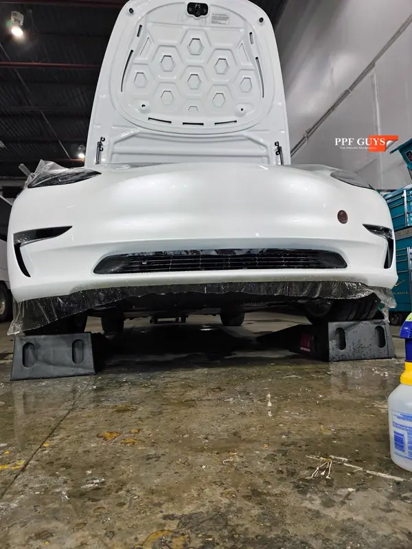White Tesla Model 3, PPF bumper scraped and replacement. Photo 10 of 10.