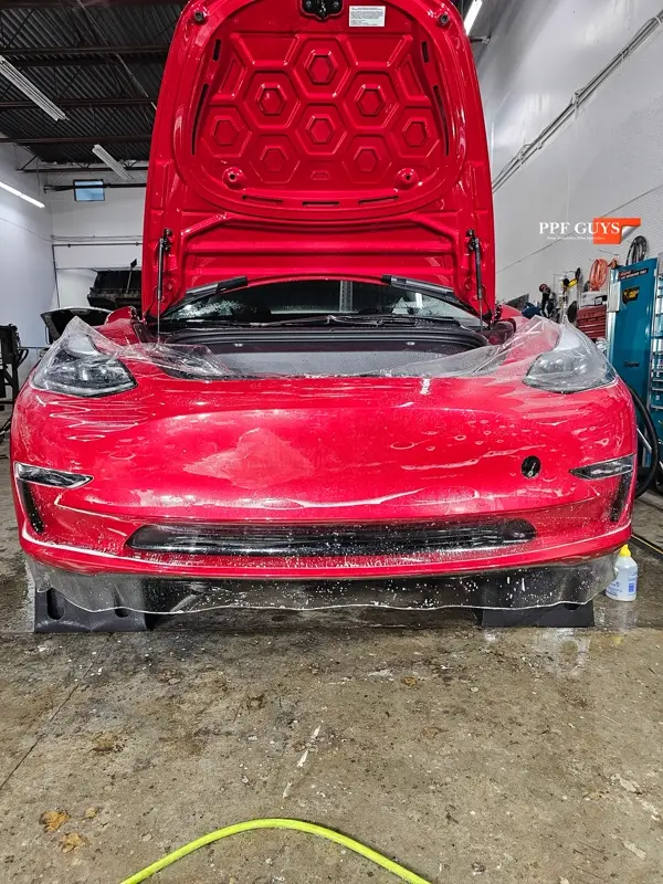 Red Tesla Model 3, Front end, partial A-pillars and rockers