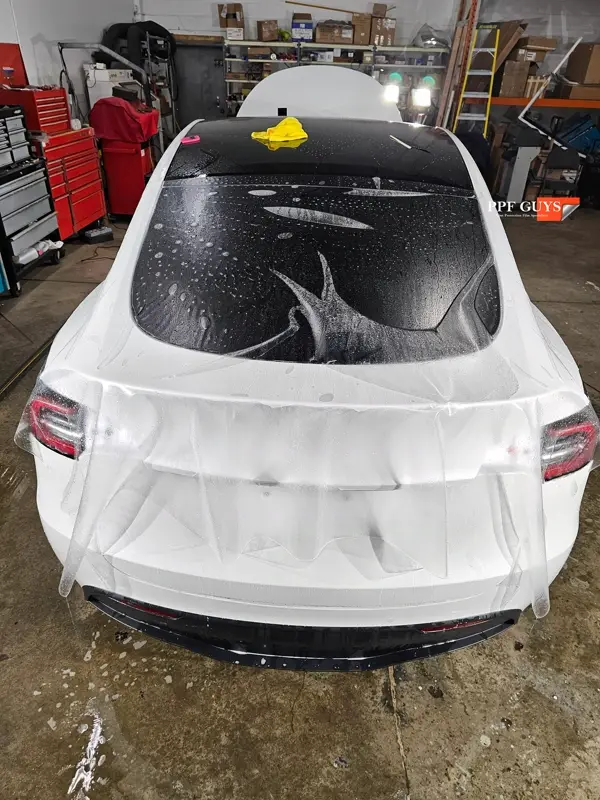 White Tesla Model Y Performance, Stealth, emblems. Photo 21 of 60.