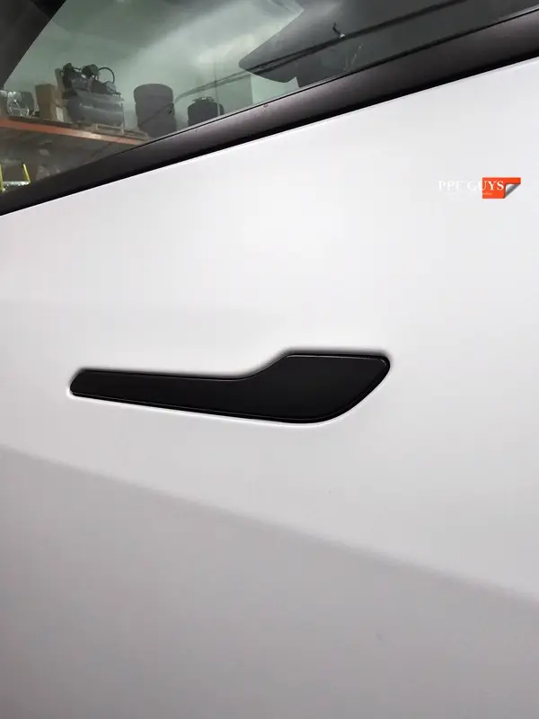 White Tesla Model Y Performance, Stealth, emblems. Photo 29 of 60.