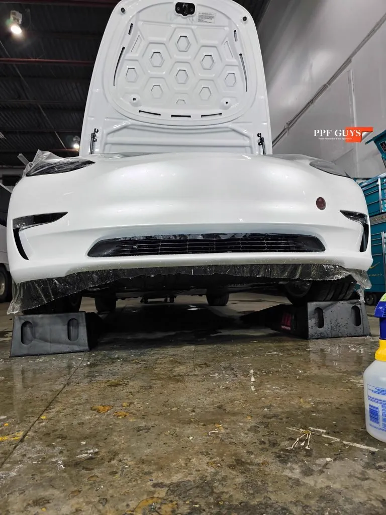 Model 3 bumper with new PPF being installed.