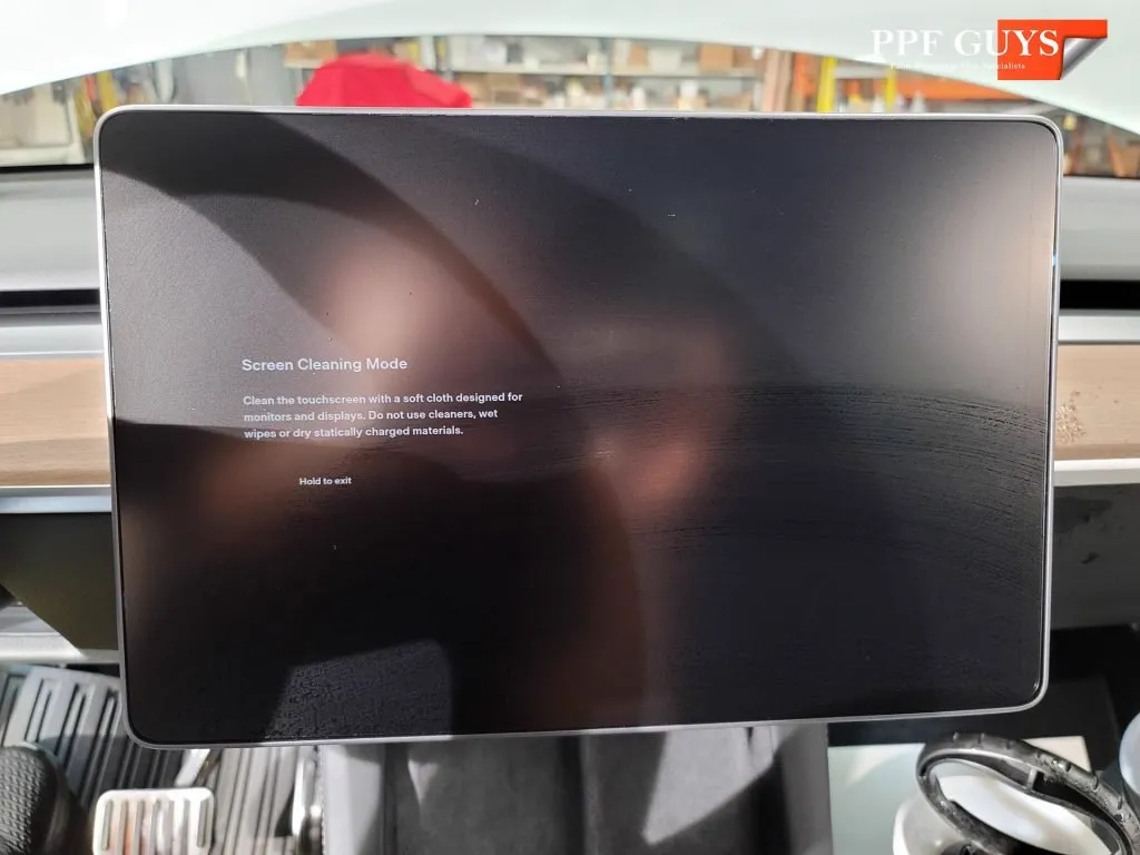 Tesla touch screen protected with clear film.